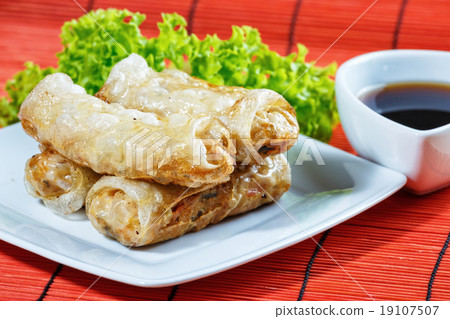 fried spring rolls on red bamboo mat fried spring rolls on red bamboo mat 19107507