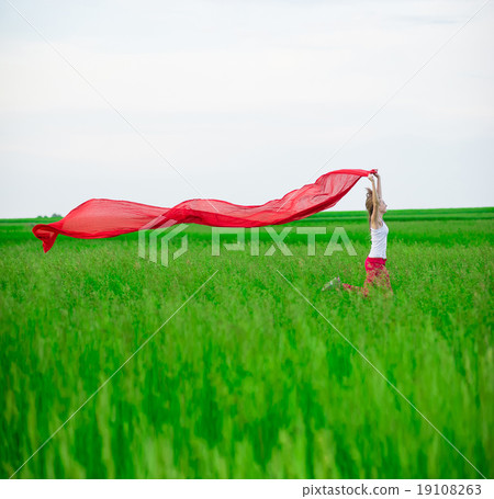 Young lady runing with tissue in green field 19108263