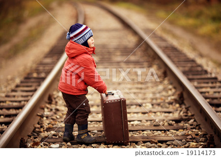 little traveler with a suitcase on the railroad 19114173
