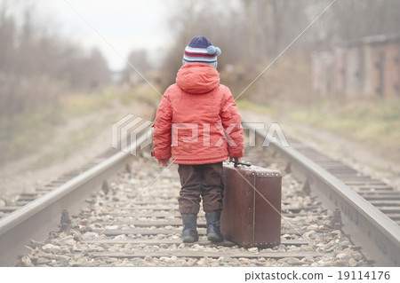 little traveler with a suitcase on the railroad 19114176