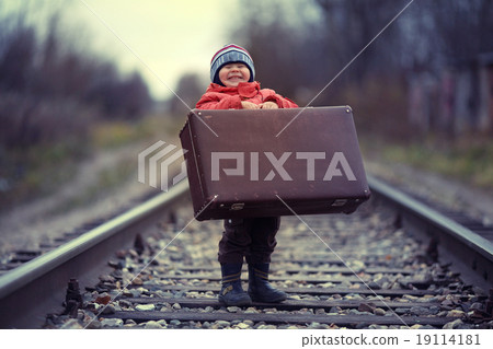 little traveler with a suitcase on the railroad 19114181