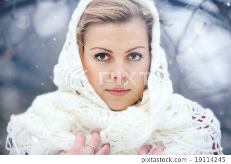 beautiful blonde in a traditional Russian scarf winter snow 19114245