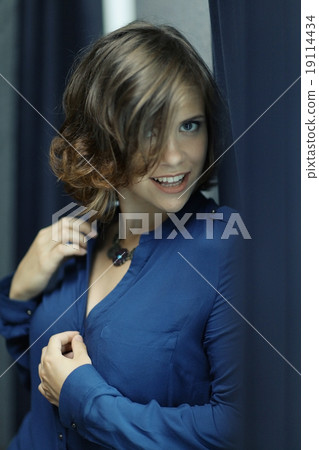 Portrait of a cheerful girl in a sexy blue 19114434