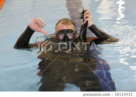 man teaches diving in the pool, swim coach man teaches diving in the pool, swim coach 19114531