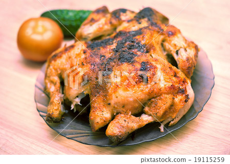 Delicious baked chicken on plate on table close-up Delicious baked chicken on plate on table close-up 19115259