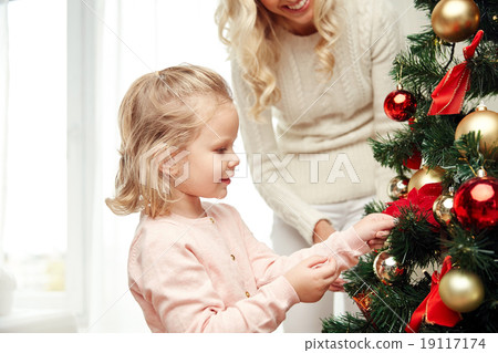 happy family decorating christmas tree at home 19117174
