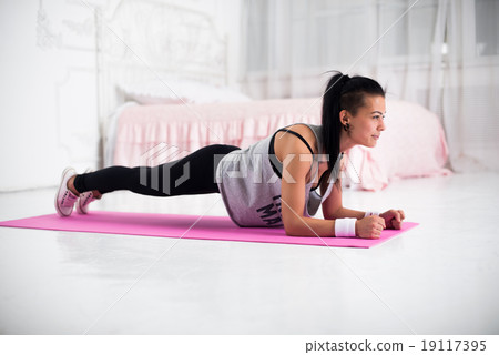 Slim fitness young woman Athlete girl doing plank 19117395