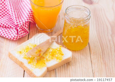 Breakfast with bread, jam and orange juice on wood table 19117457