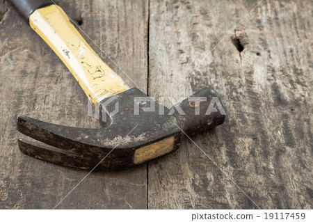 Old rusty hammer on wooden background Old rusty hammer on wooden background 19117459