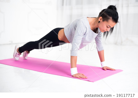 teenage girl doing push ups warming up working at 19117717