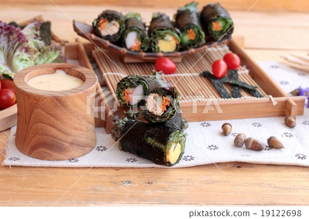 Vegetable salad wrapped with seaweed into spring rolls. Vegetable salad wrapped with seaweed into spring rolls. 19122698