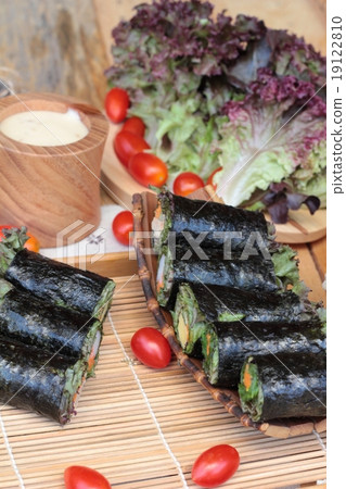 Vegetable salad wrapped with seaweed into spring rolls. Vegetable salad wrapped with seaweed into spring rolls. 19122810