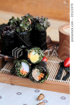 Vegetable salad wrapped with seaweed into spring rolls. 19122870