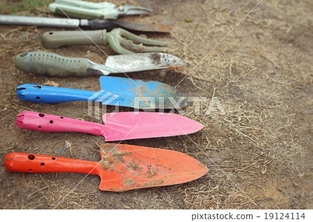 Shovel and fork for gardening on soil background Shovel and fork for gardening on soil background 19124114