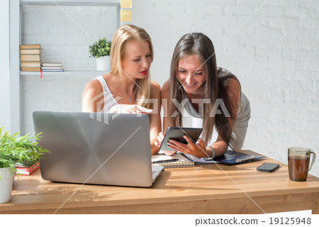 Businesswoman showing something to colleague on 19125948