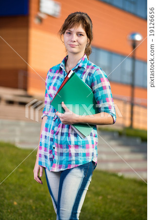 Portrait of young alluring woman holding education books. Student girl. 19126656