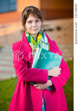 Portrait of young alluring woman holding education books. Student girl. 19126693