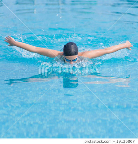 Young girl swimming butterfly stroke style Young girl swimming butterfly stroke style 19126807