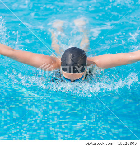 Young girl swimming butterfly stroke style Young girl swimming butterfly stroke style 19126809