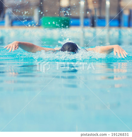 Young girl swimming butterfly stroke style Young girl swimming butterfly stroke style 19126831