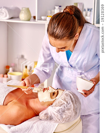 Stock Photo: Woman middle-aged take face massage in spa salon.