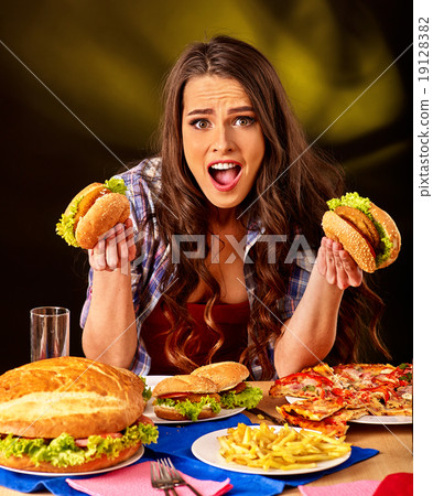 Girl eating big sandwich. Girl eating big sandwich. 19128382