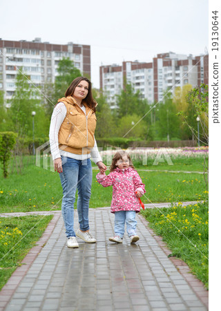Mother And Daughter Walking Along Path Mother And Daughter Walking Along Path 19130644