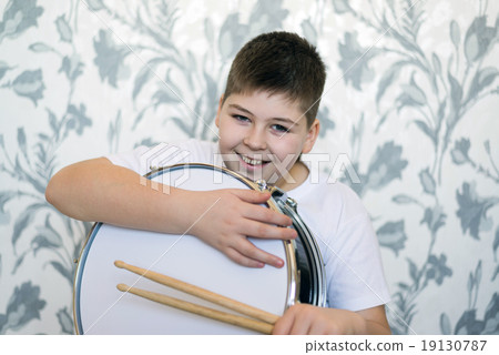 Teenager boy with a drum in  room 19130787