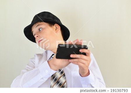 Boy teenager turns away from cell phone Boy teenager turns away from cell phone 19130793
