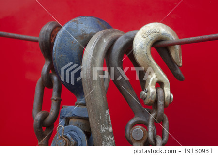 metal hooks on a cord red background 19130931