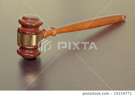 Judge gavel on wooden table in court. 19134771