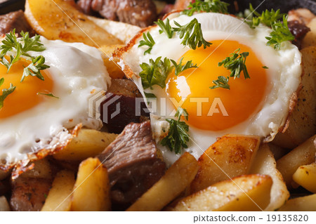 fried potatoes with meat, bacon and eggs macro 19135820