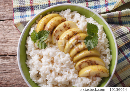 Rice with caramelized apples in a bowl close-up 19136034