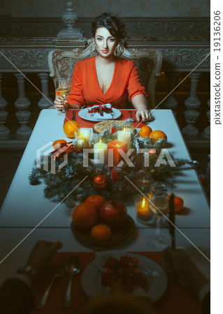 Woman at the festive table. 19136206