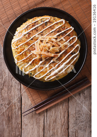 Japanese okonomiyaki on a wooden table. top view Japanese okonomiyaki on a wooden table. top view 19136416