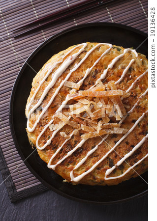 Japanese okonomiyaki pizza close-up top view Japanese okonomiyaki pizza close-up top view 19136428