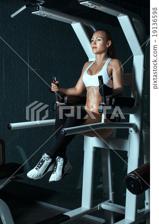 Girl has been on the simulator currently shaking stomach muscles. Girl has been on the simulator currently shaking stomach muscles. 19136598