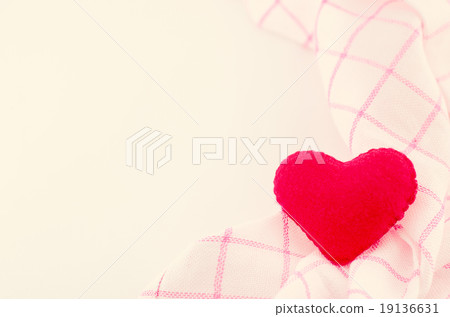 Red heart and pink fabric on white background 19136631