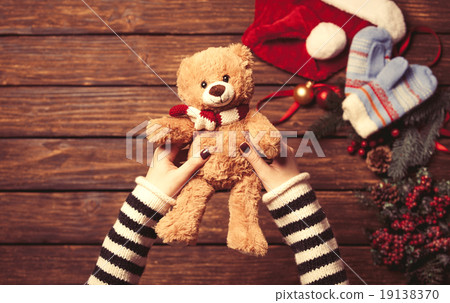 Female holding a little teddy bear 19138370