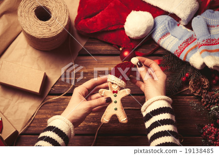 Woman wrapping a christmas cookie 19138485