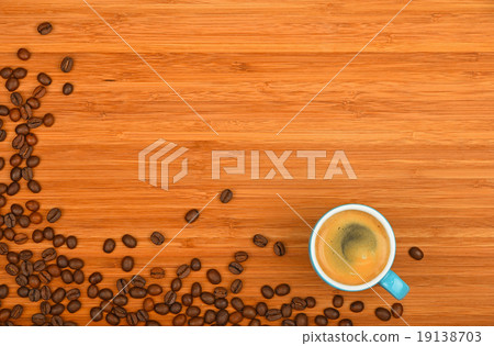 Coffee cup and beans over wood background Coffee cup and beans over wood background 19138703