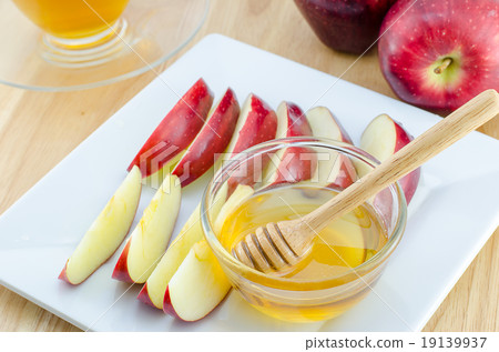Apple with honey in plate on wooden table 19139937