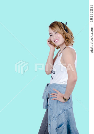 Happy Asian woman using headphone listening music Happy Asian woman using headphone listening music 19152852