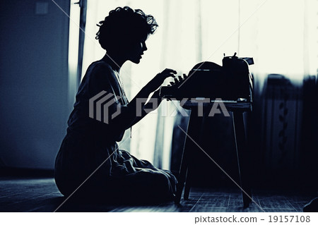girl typing on a typewriter girl typing on a typewriter 19157108