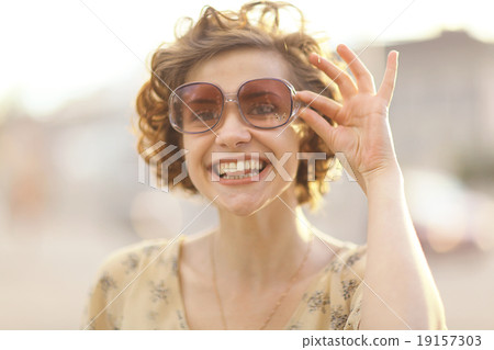 summer portrait of a cheerful girl 19157303