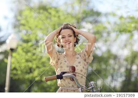 girl in a dress on a bicycle 19157309