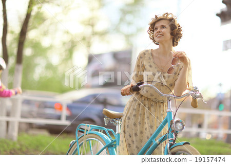girl in a dress on a bicycle 19157474