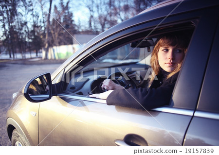 portrait of a girl in a car driver at the wheel 19157839