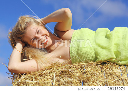 beautiful young blond lying on the grass yellow beautiful young blond lying on the grass yellow 19158074