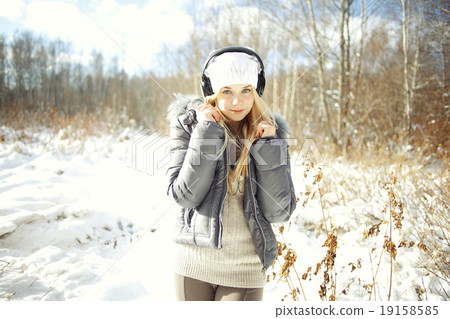 Winter portrait of young girl with headphones music Winter portrait of young girl with headphones music 19158585